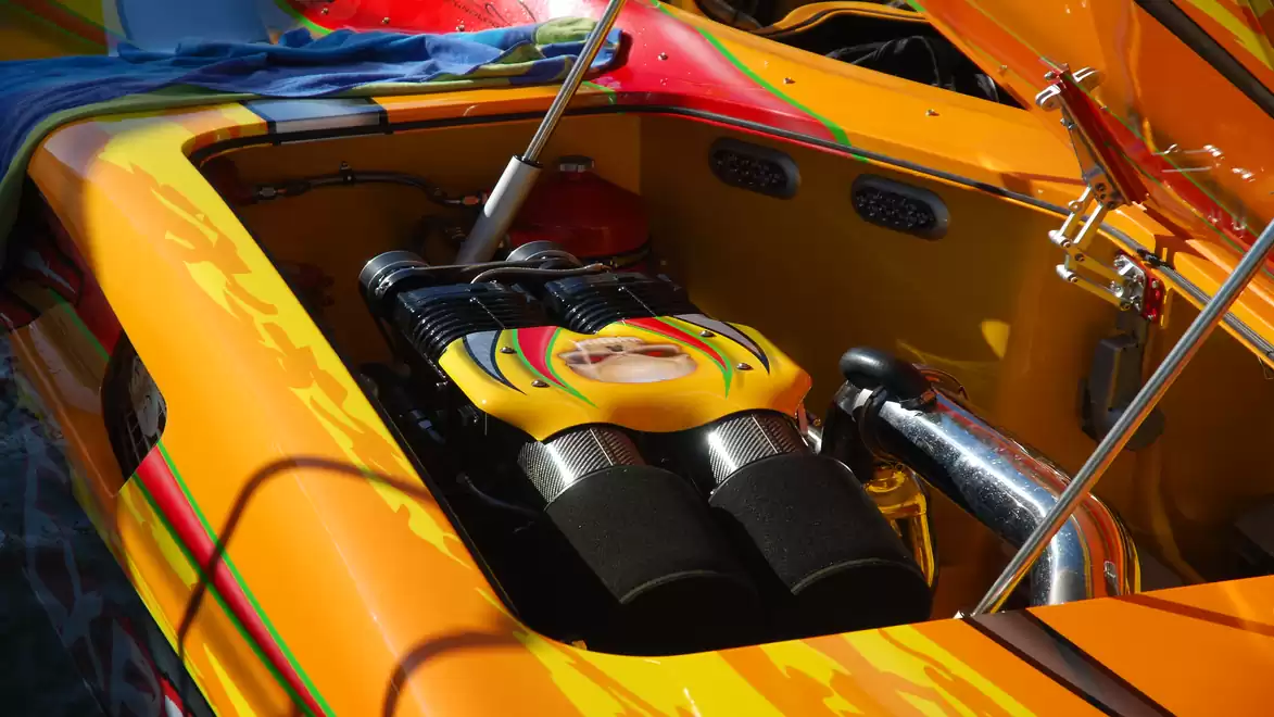 Close-up of a brightly colored orange boat engine with vibrant accents and standout design.