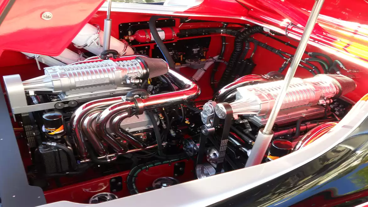 Two powerful boat engines in a bright engine compartment