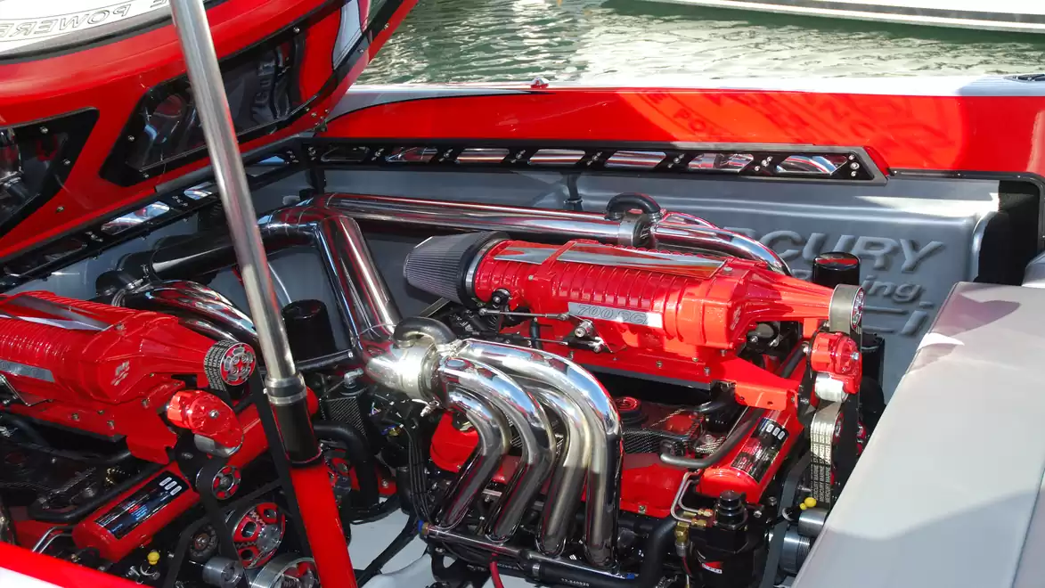 Close-up of a powerful red boat engine with shiny metal parts.