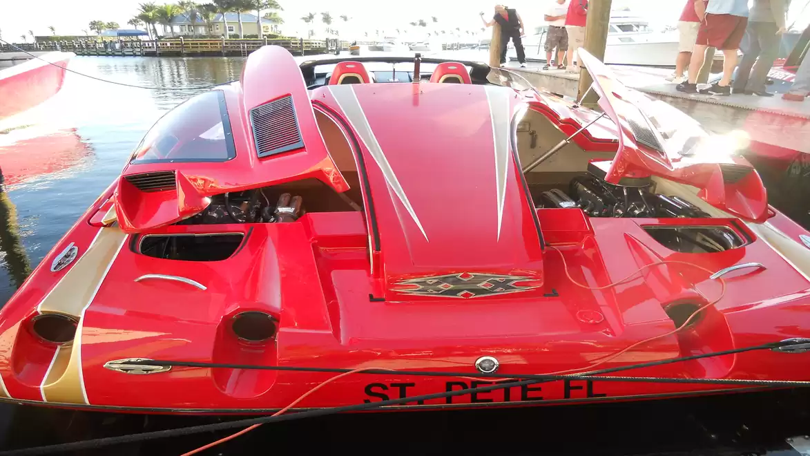 Red speedboat with open engine compartment at the dock in St. Petersburg, Florida.