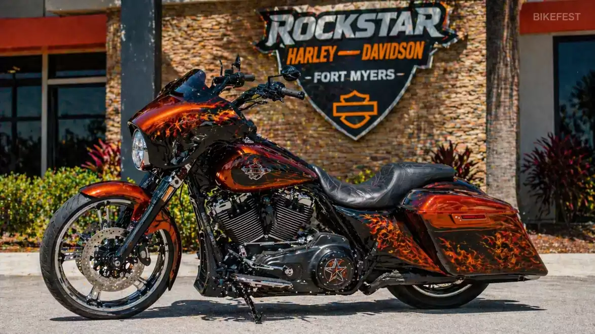 Custom Harley-Davidson motorcycle with flame design in front of a Rockstar Harley-Davidson store in Fort Myers.