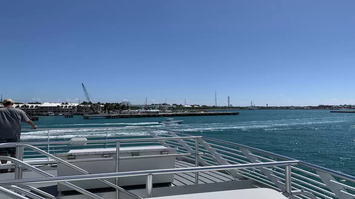 A boat on a blue sea with a clear sky in the background during daytime.