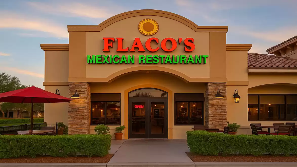 Exterior view of a Mexican restaurant with a lit sign and symmetrical entrance, Flaco's Mexican Restaurant.