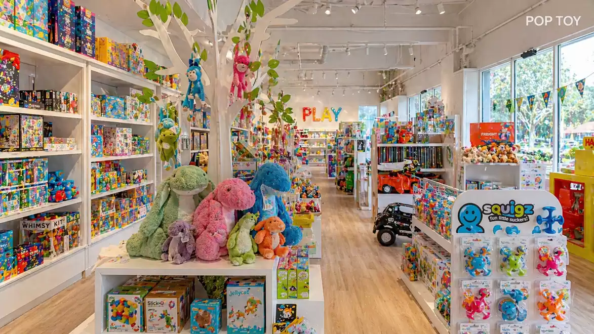 Bright and inviting toy store with colorful shelves, stuffed animals, and toys.