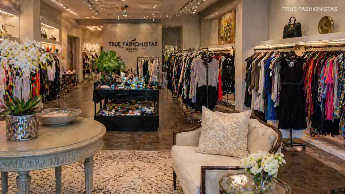 Interior view of a stylish clothing store with elegant decor and diverse fashion offerings.
