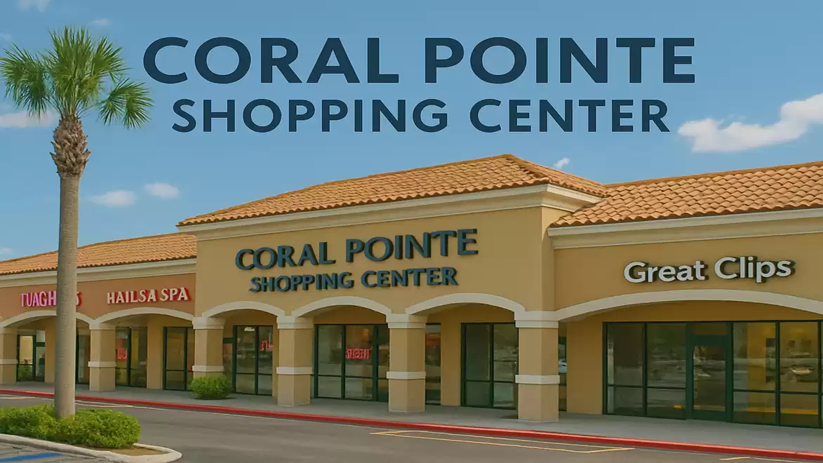 Exterior view of Coral Pointe Shopping Center with palm tree and stores under a blue sky.