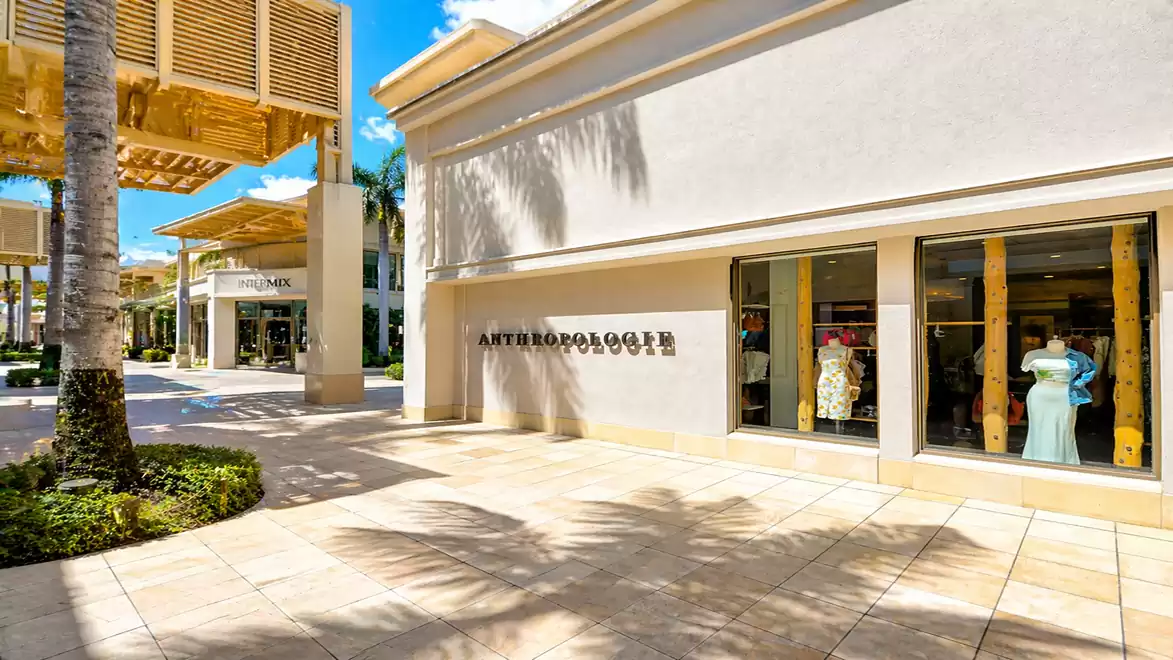 Exterior view of a shopping center with a store and showcase. The building displays the name 'Anthropologie'.