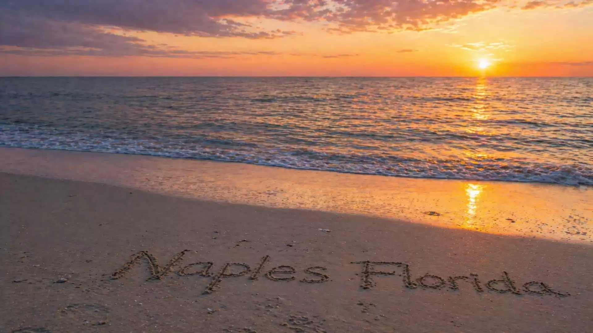 Sunset at the beach in Naples, Florida, with writing in the sand.