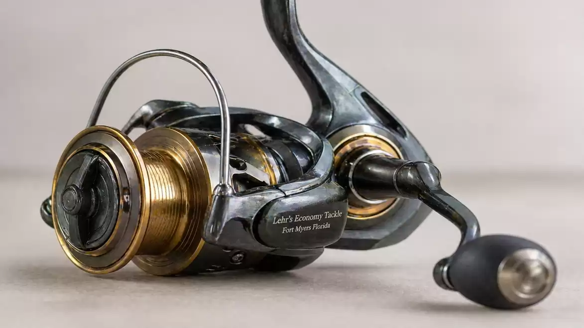 High-quality fishing reel made of metal with gold and black details, ideal for sport anglers.