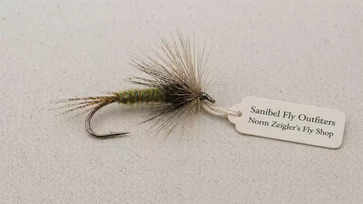 A fly fishing lure with a tag from Sanibel Fly Outfitters, Norm Zeigler's Fly Shop.