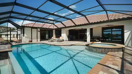 The large pool area includes a covered patio and sundeck, pool and spa