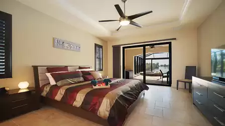 The master bedroom offers a King size bed and access to the pool area