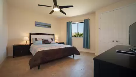 A Queen size bed can be found in this bedroom