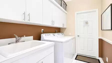 Laundry room with washbasin, efficient washing machine and dryer