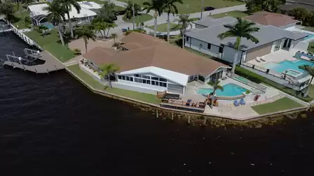 View from above of the side canal, the sun terrace and the pool