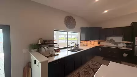 Fully equipped kitchen in the modern black and white trend with serving window to the covered terrace