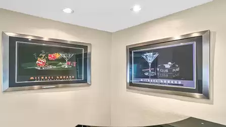 The billiard room has a small bar and matching pictures on the wall