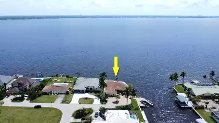 View from above of the villa, the river and the large boat dock