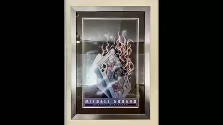The painting Burning BlackJack by Michael Godaro hangs on the wall here
