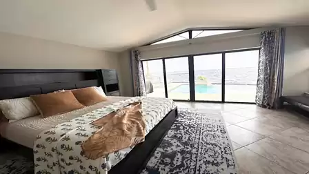 From the master bedroom, large sliding glass doors open up this magnificent view of the water