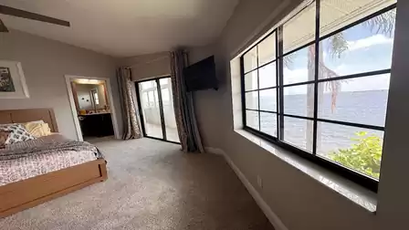 Bedroom with large window, TV, attached bathroom and access to the terrace