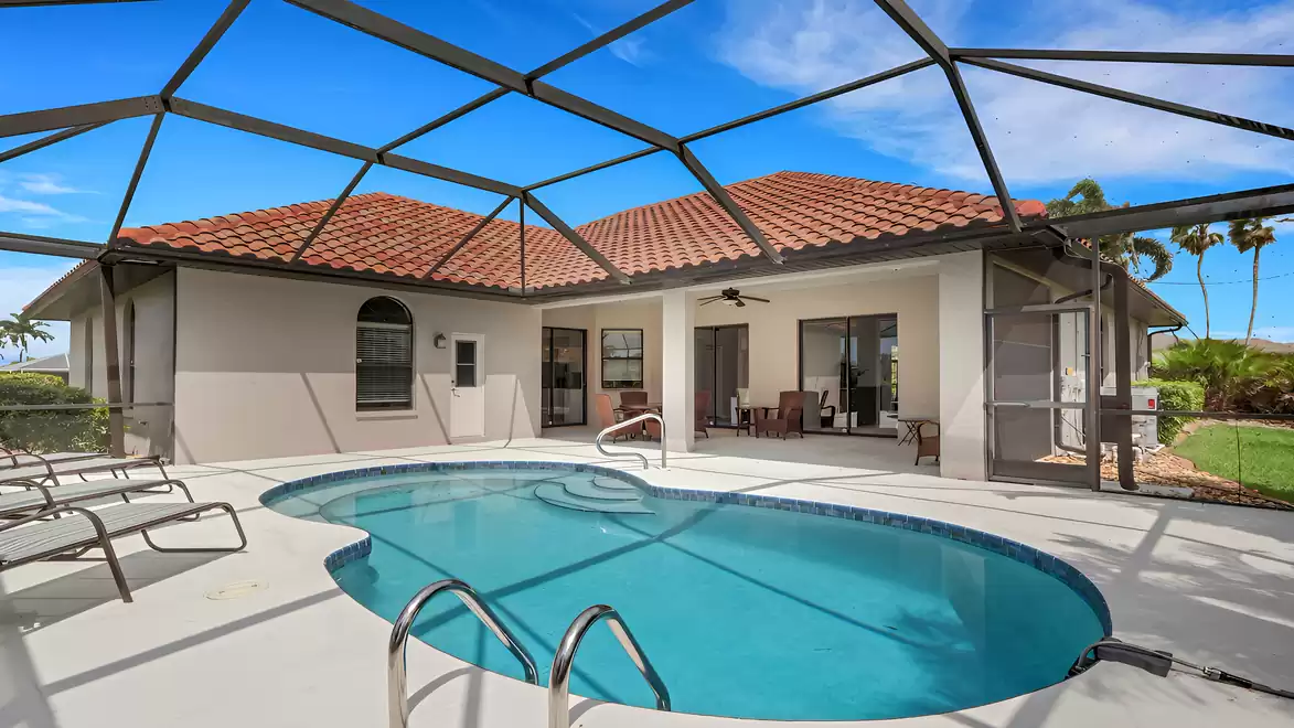 Villa Shakira Cape Coral vacation home screened pool area with loungers and terrace