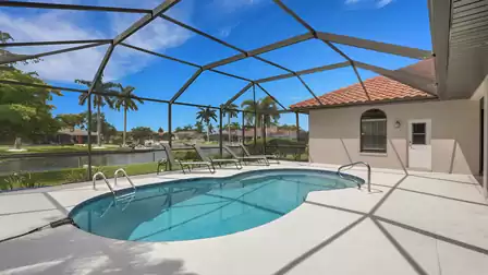Villa Shakira Cape Coral vacation home screened pool deck with canal view and loungers