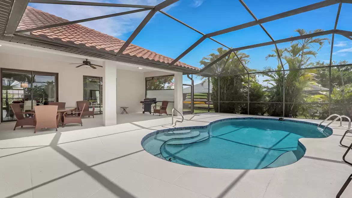 Villa Shakira Cape Coral vacation home screened lanai with pool, grill and dining set