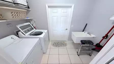 Laundry room with washing machine, dryer and access to the garage