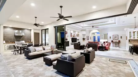 The large covered patio includes both dining and sitting areas