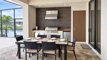 Next to the dining area is a summer kitchen with grill on the patio