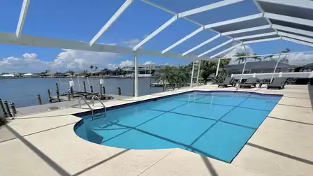 Relax on the sun loungers and enjoy the view of the pool and the lake