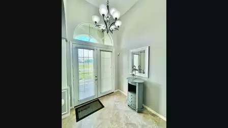  The wide double door entry opens onto the foyer