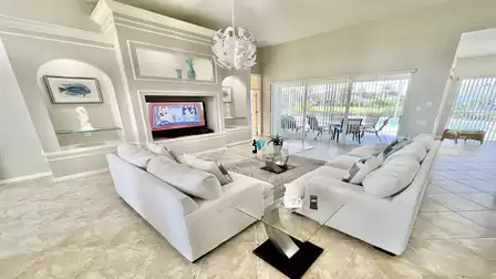 The living room is equipped with a large TV