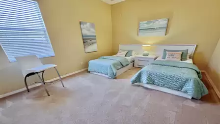 The third bedroom is furnished with two single beds
