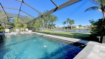 View over the pool, garden and the canal to the east