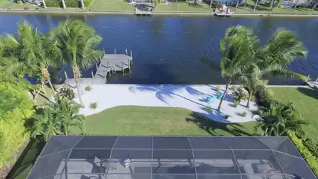 View over Villa Pandora to the private beach and the canal