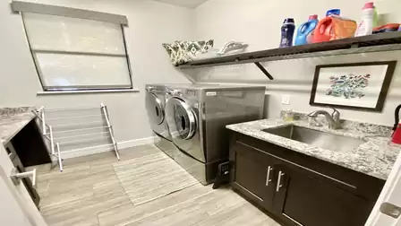 The laundry room offers high-end washer and dryer