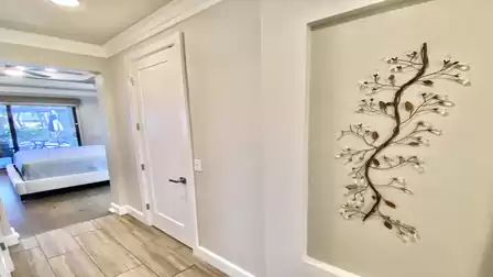 Hallway to the bedroom with modern picture on the wall