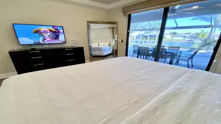 The bedroom is equipped with a large TV