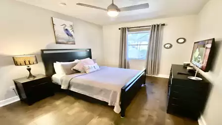 A Queen size bed is set up in the second bedroom