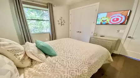 This bedroom also features a large TV