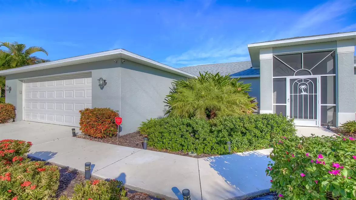 The home is surrounded by manicured landscaping