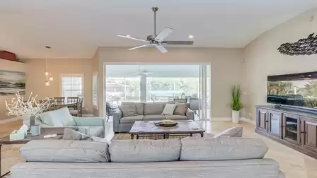 Sliders lead out from the living room to the pool area