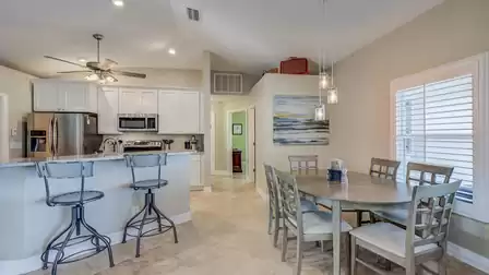 Next to the dining room, there are additional places to sit along the breakfast bar