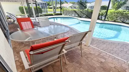 Dining area and lounge chairs can be found on the covered patio