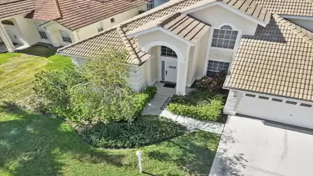 The house is surrounded by a tropical garden