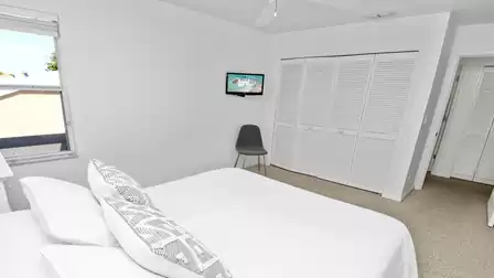 This bedroom is equipped with a small TV