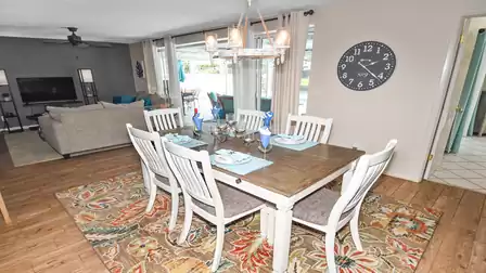 Large sliding glass doors open up the living/dining area to the terrace