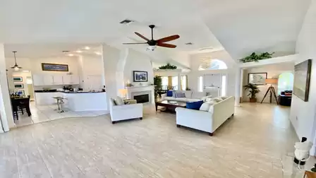 Elegant white sofa oasis and white eat-in kitchen